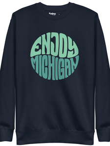 Enjoy Michigan 70's Retro Premium Sweatshirt shown in navy with a throwback 70's Enjoy Michigan circular graphic printed in greens on the front. By Enjoy Michigan.