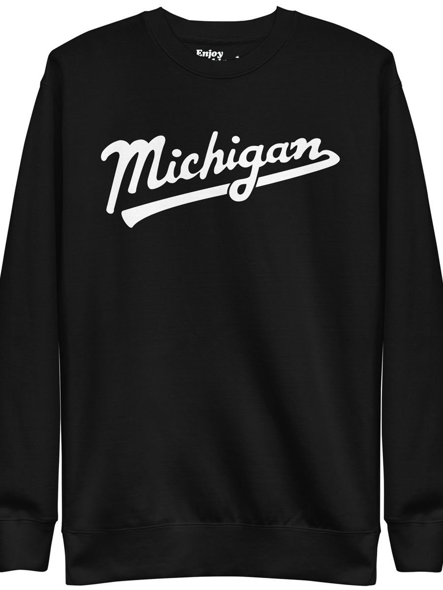 Michigan Script premium sweatshirt shown in black with a white sport-style script graphic printed on the front. By Enjoy Michigan