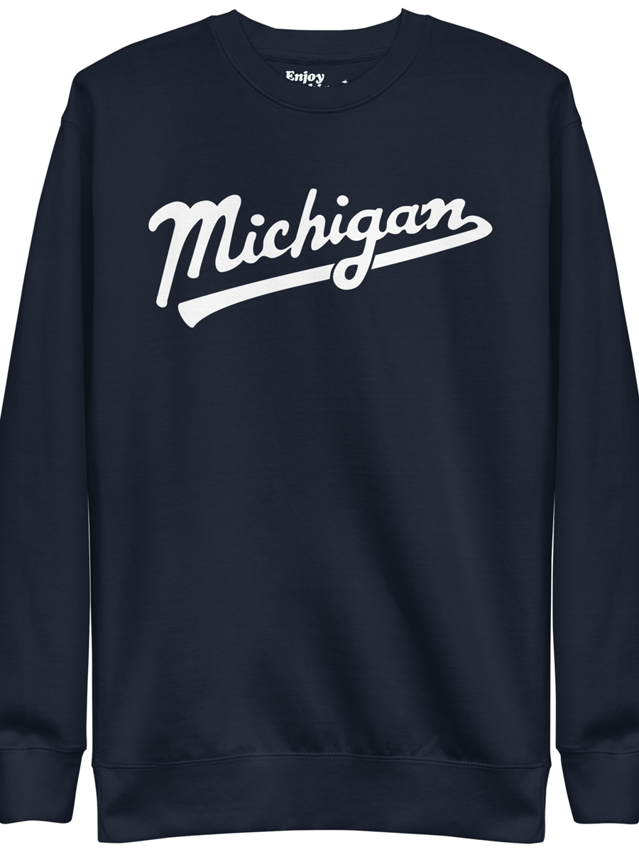 Michigan Script premium sweatshirt shown in navy with a white sport-style script graphic printed on the front. By Enjoy Michigan