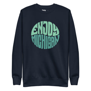 Enjoy Michigan 70's Retro Premium Sweatshirt shown in navy with a throwback 70's Enjoy Michigan circular graphic printed in greens on the front. By Enjoy Michigan.