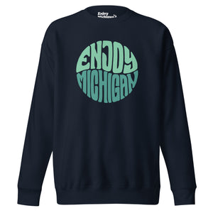 Enjoy Michigan 70's Retro Premium Sweatshirt shown in navy with a throwback 70's Enjoy Michigan circular graphic printed in greens on the front. By Enjoy Michigan.
