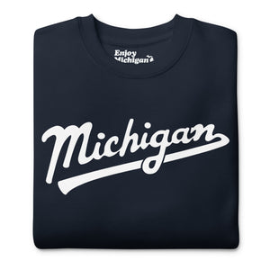 Michigan Script premium sweatshirt shown in navy with a white sport-style script graphic printed on the front. By Enjoy Michigan